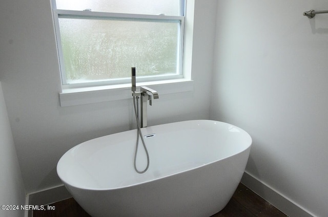 bathroom featuring a tub to relax in