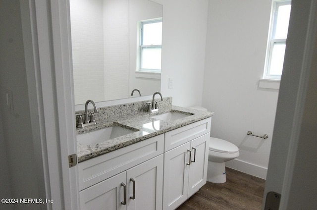 bathroom with toilet, hardwood / wood-style flooring, and vanity