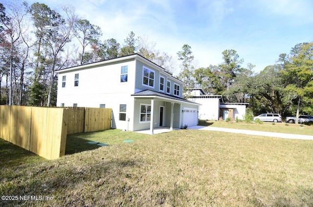 rear view of house with a garage and a lawn