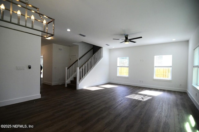 unfurnished living room with ceiling fan and dark wood-type flooring