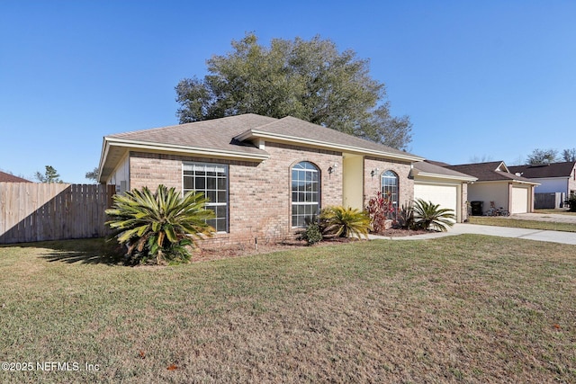 ranch-style house featuring a garage and a front lawn