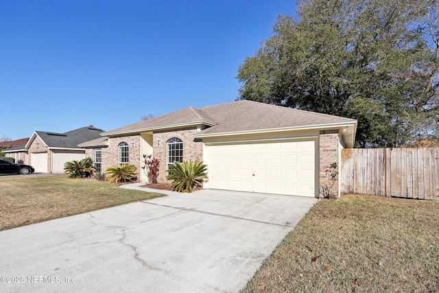 ranch-style home with a front lawn and a garage