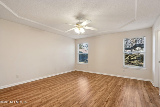 spare room featuring ceiling fan, hardwood / wood-style floors, and a textured ceiling