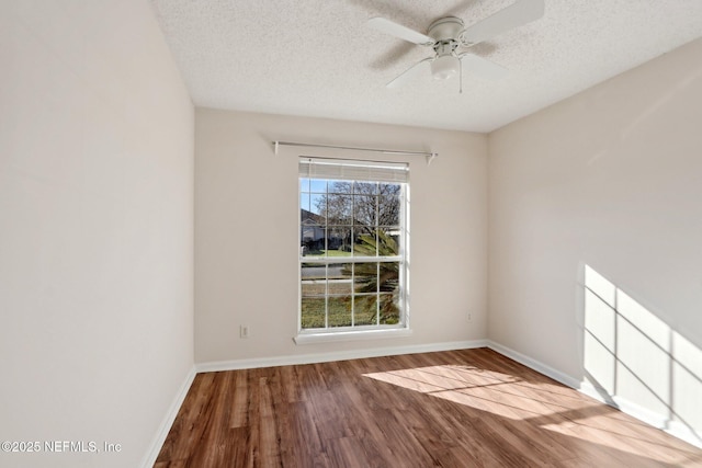 empty room featuring hardwood / wood-style floors, ceiling fan, and a textured ceiling