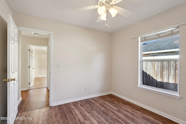 unfurnished room featuring ceiling fan and wood-type flooring