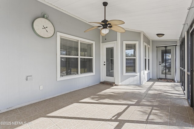 sunroom / solarium featuring ceiling fan