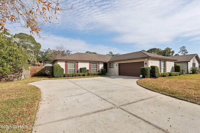 ranch-style home with a garage and a front lawn