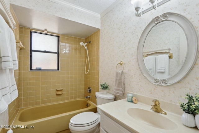 full bathroom featuring tiled shower / bath, vanity, toilet, crown molding, and a textured ceiling