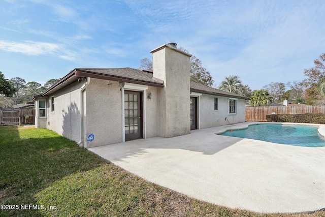 view of swimming pool featuring a yard and a patio area