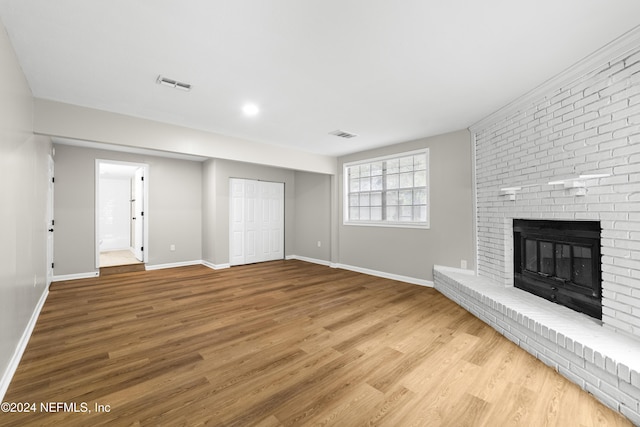 unfurnished living room featuring a fireplace and hardwood / wood-style flooring