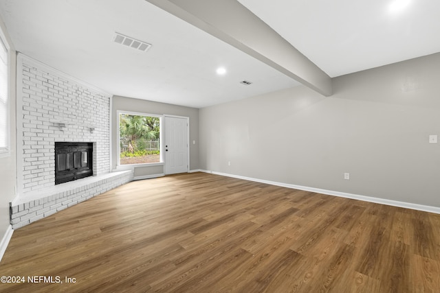 unfurnished living room featuring a fireplace and hardwood / wood-style floors