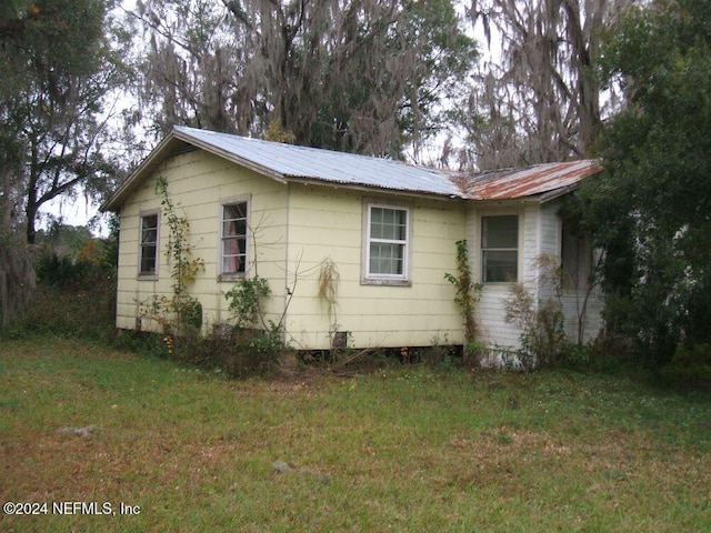 view of home's exterior with a lawn