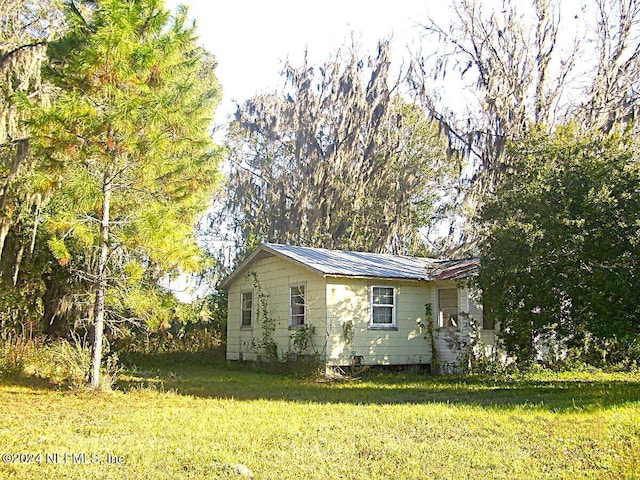 view of side of home featuring a lawn