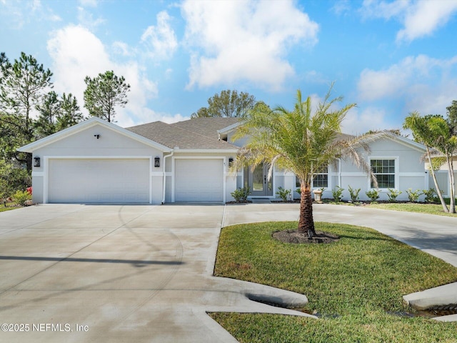 view of front of house featuring a garage and a front lawn