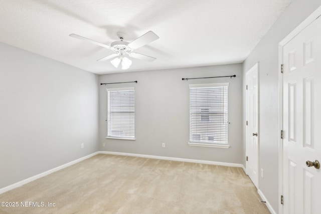 empty room with a healthy amount of sunlight, light carpet, a textured ceiling, and ceiling fan