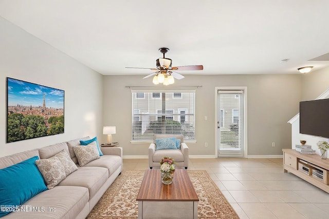 tiled living room featuring ceiling fan