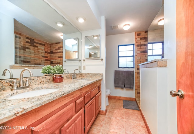 bathroom with a shower, tile patterned flooring, vanity, and toilet