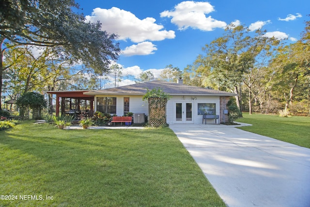 view of front of house featuring central air condition unit, french doors, and a front yard