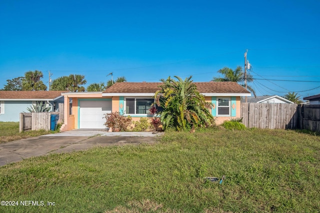 ranch-style house with a garage and a front lawn