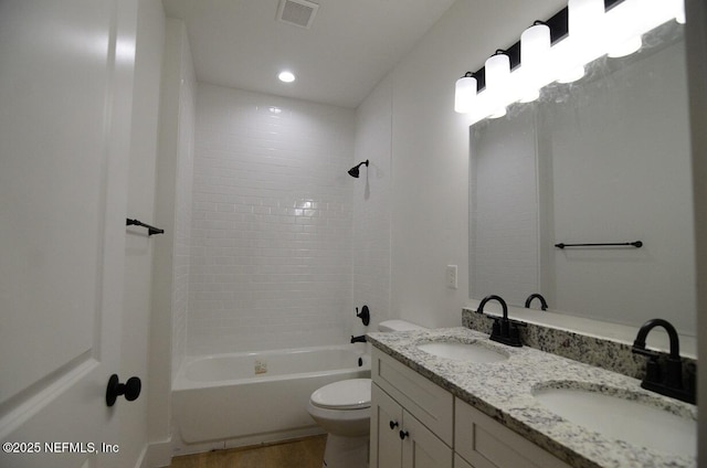 full bathroom with toilet, vanity, tiled shower / bath combo, and hardwood / wood-style flooring