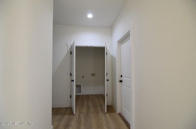 corridor with light hardwood / wood-style floors