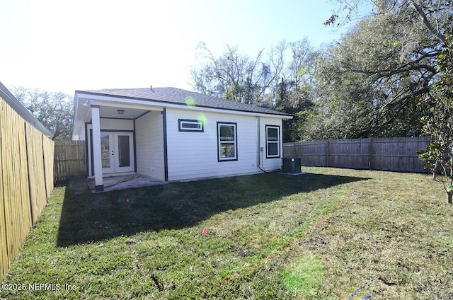 back of property featuring a yard, central AC, and french doors