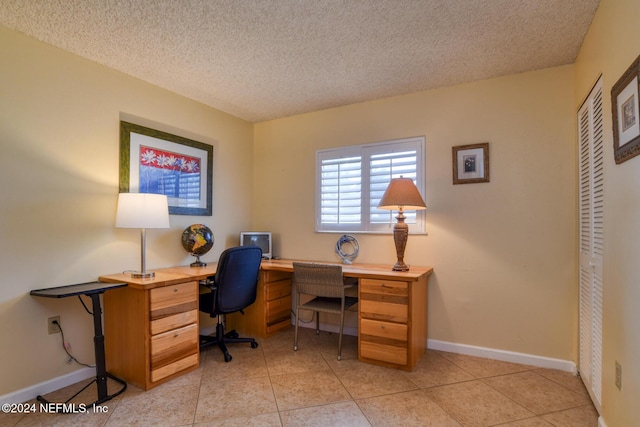 tiled office with a textured ceiling