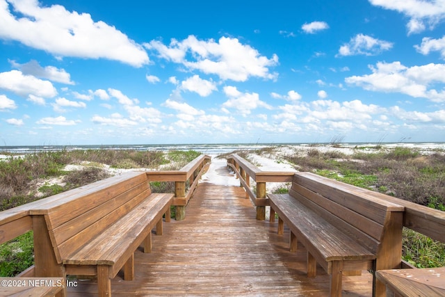 surrounding community featuring a water view and a view of the beach