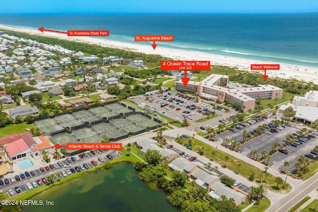 birds eye view of property with a water view and a view of the beach