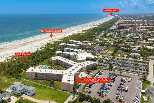 bird's eye view featuring a view of the beach and a water view