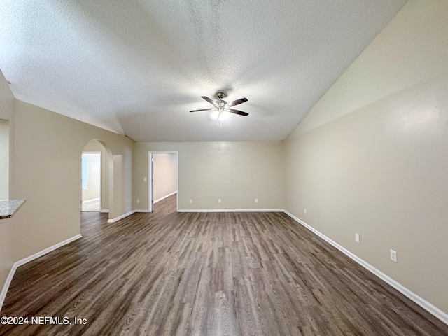 spare room featuring a textured ceiling, dark hardwood / wood-style floors, ceiling fan, and lofted ceiling