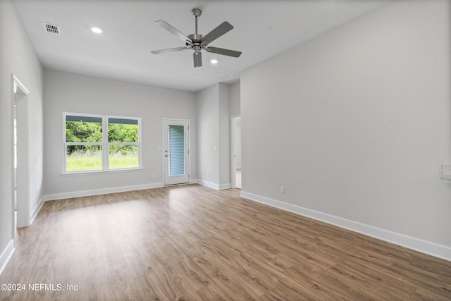 unfurnished room with baseboards, visible vents, wood finished floors, and recessed lighting