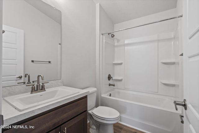 full bathroom featuring  shower combination, vanity, toilet, and wood finished floors