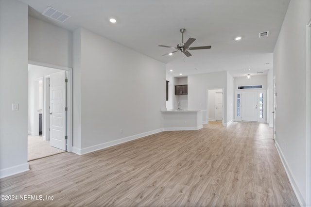 unfurnished living room with light wood finished floors, visible vents, a ceiling fan, and recessed lighting