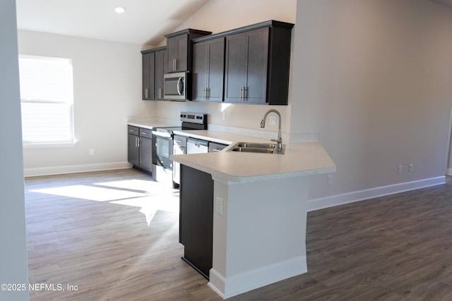 8159 Elsdon St, Jacksonville, FL 32219 - kitchen with a sink, light countertops, light wood finished floors, stainless steel appliances, and lofted ceiling