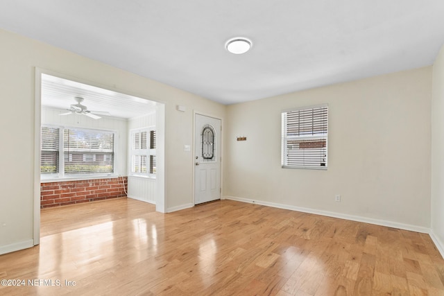 foyer entrance with ceiling fan and light hardwood / wood-style flooring