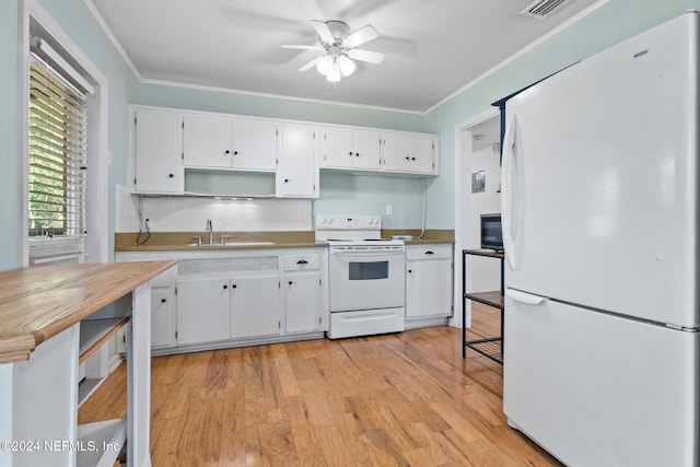 kitchen with white cabinetry, sink, light hardwood / wood-style flooring, white appliances, and decorative backsplash