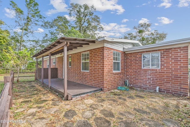 view of side of home with a deck