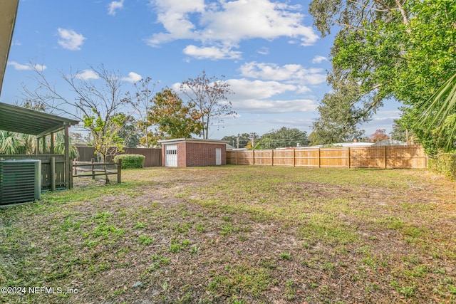 view of yard with an outbuilding and central air condition unit