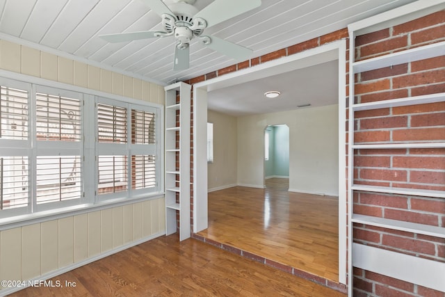 empty room with ceiling fan and wood-type flooring