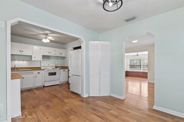 kitchen with white cabinets, white appliances, light hardwood / wood-style flooring, and sink