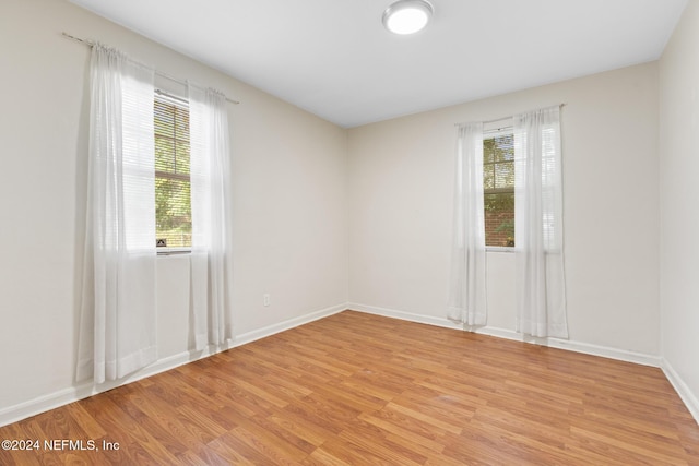 unfurnished room featuring light hardwood / wood-style flooring