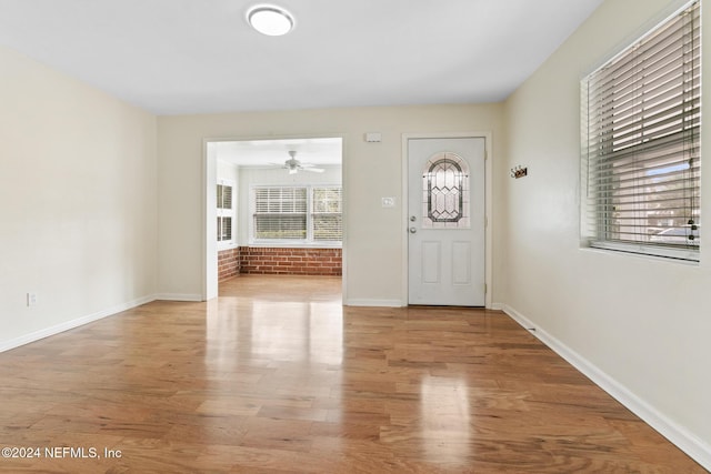 foyer with ceiling fan and light wood-type flooring