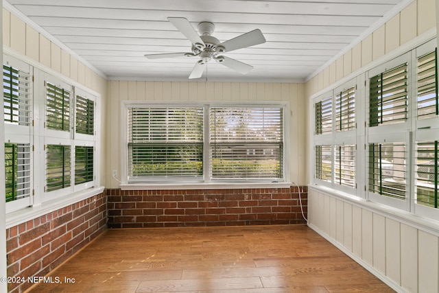 unfurnished sunroom featuring ceiling fan