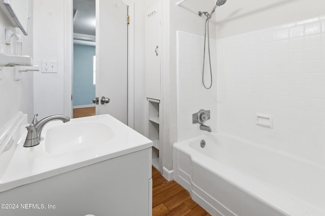 bathroom featuring vanity, wood-type flooring, and bathtub / shower combination