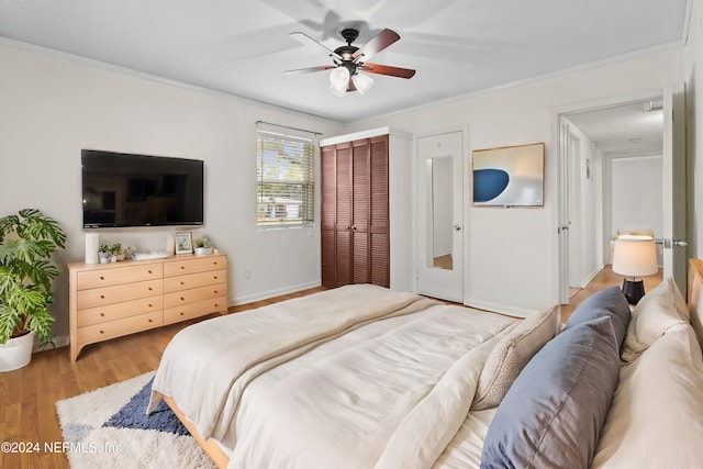 bedroom with ceiling fan, light wood-type flooring, and ornamental molding