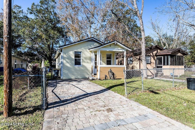 bungalow-style home with a front lawn and a porch