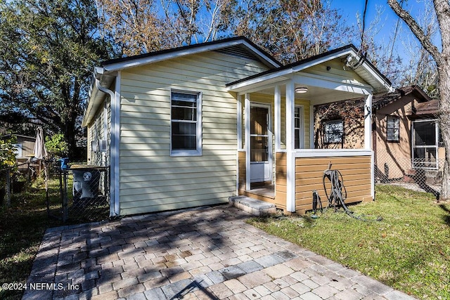 bungalow-style home featuring a front yard