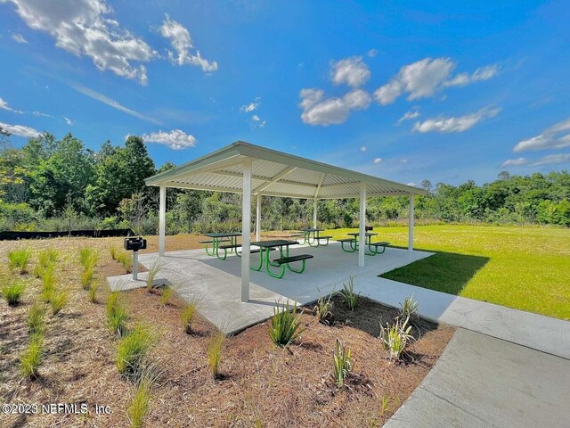 view of home's community with a lawn and a gazebo