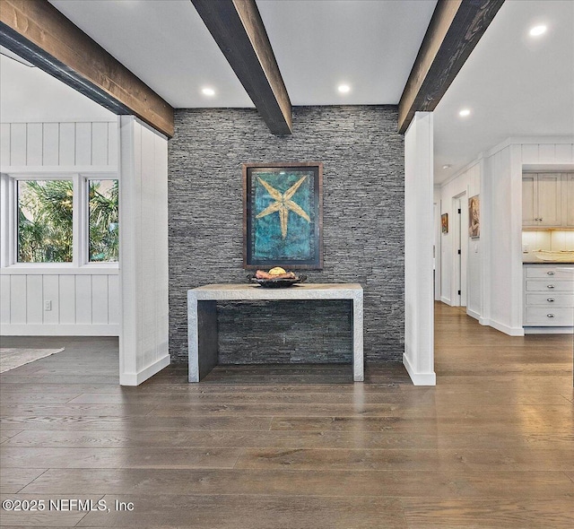 living room with dark hardwood / wood-style flooring and beam ceiling